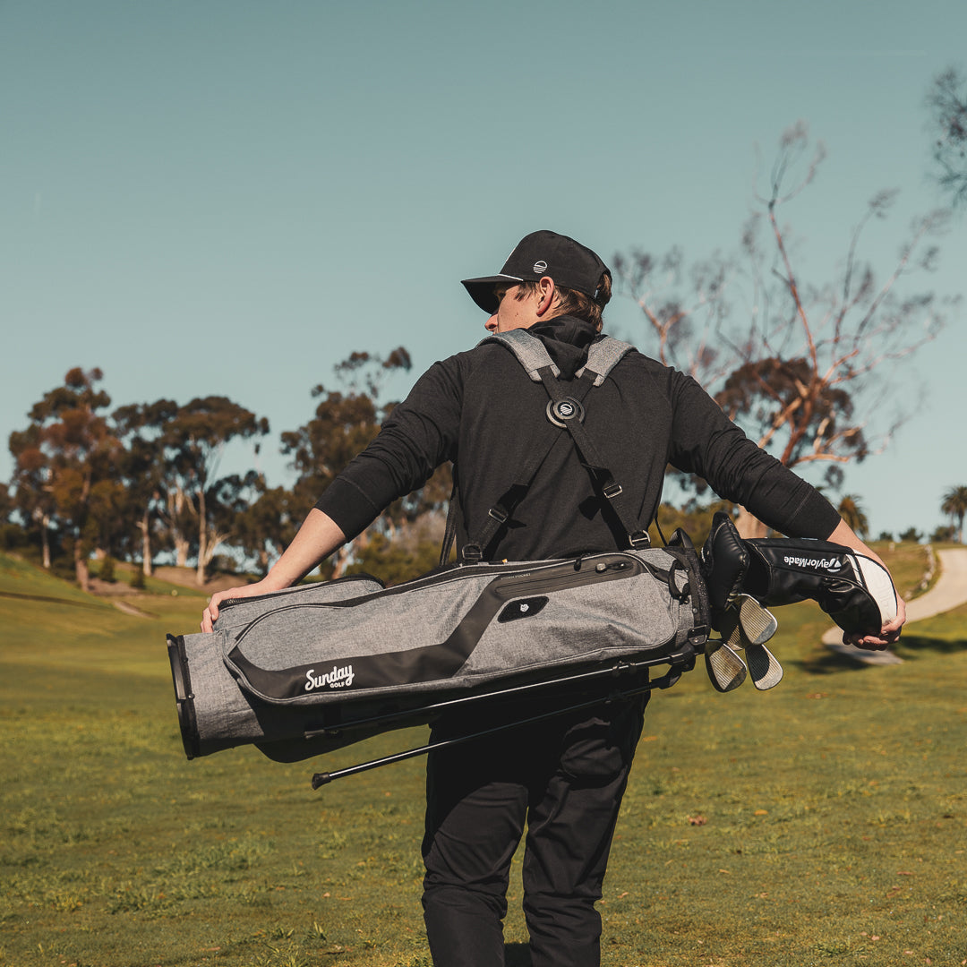 man carrying grey El Camino golf bag by Sunday Golf