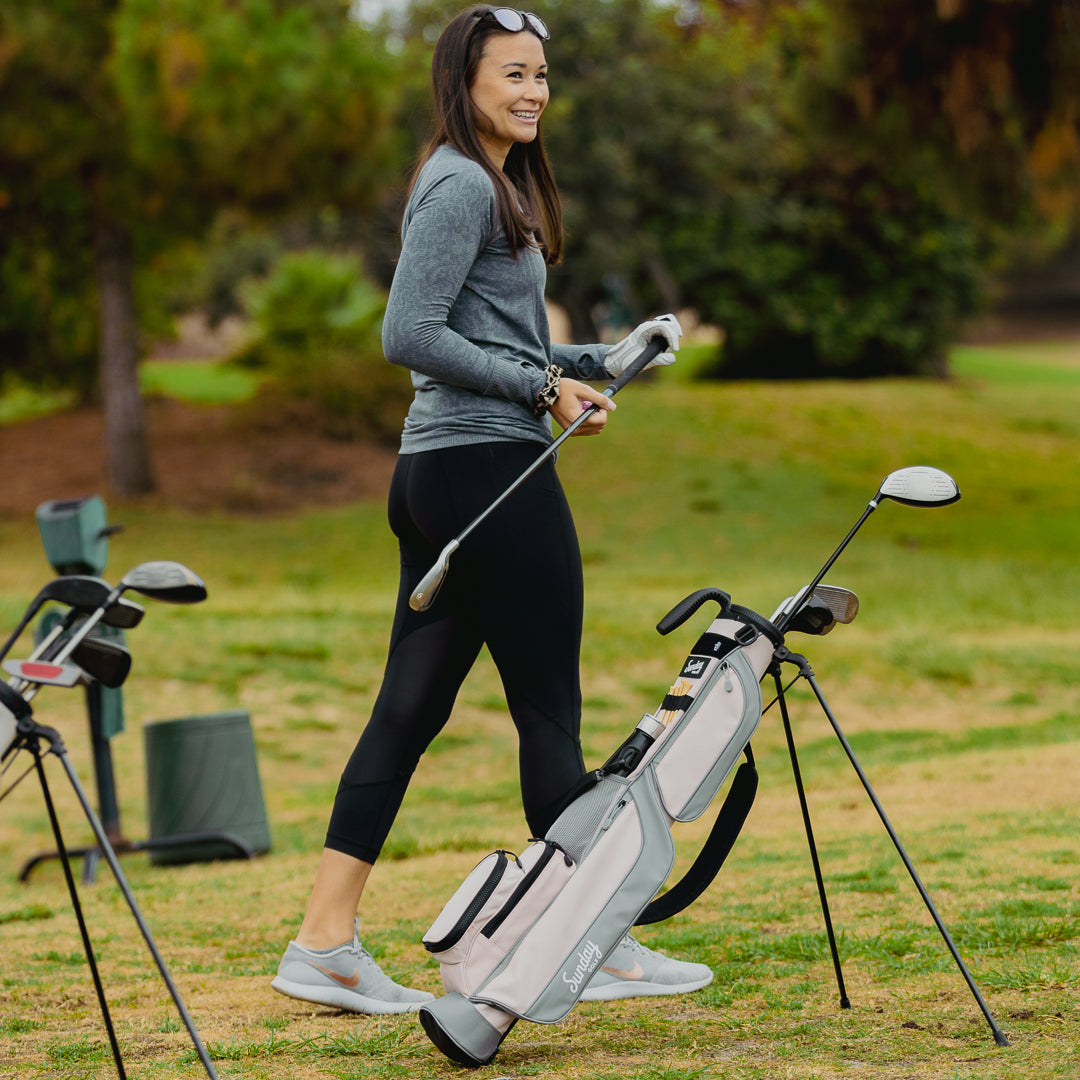 female golfer with flamingo pink Loma Bag by Sunday Golf