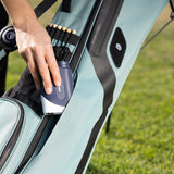 woman putting range finder into seafoam green El Camino golf bag by Sunday Golf
