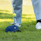 bouncing golf ball on club with the porter lite golf hat in navy by sunday golf 