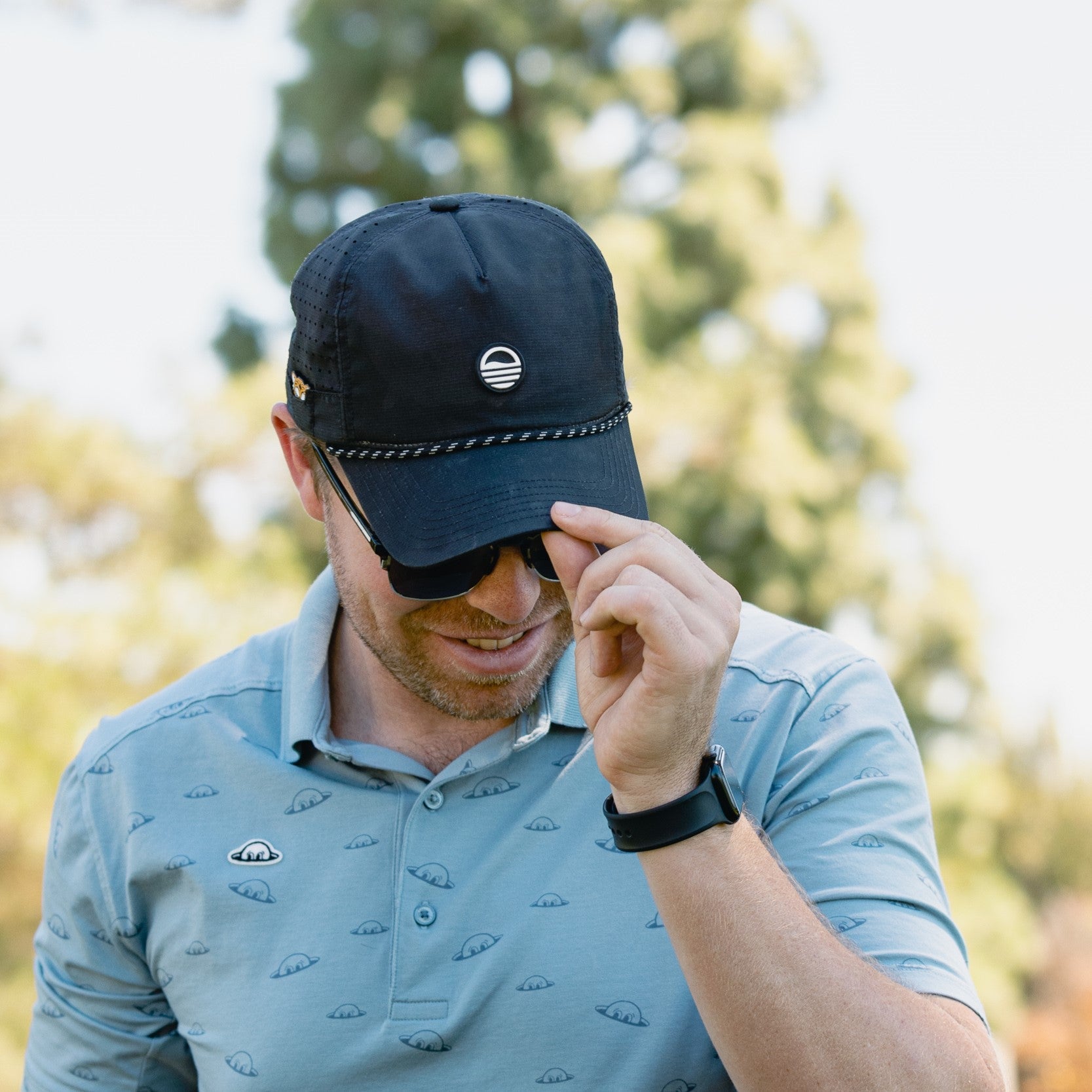 man wearing black sunday golf porter lite SUNDAZE hat